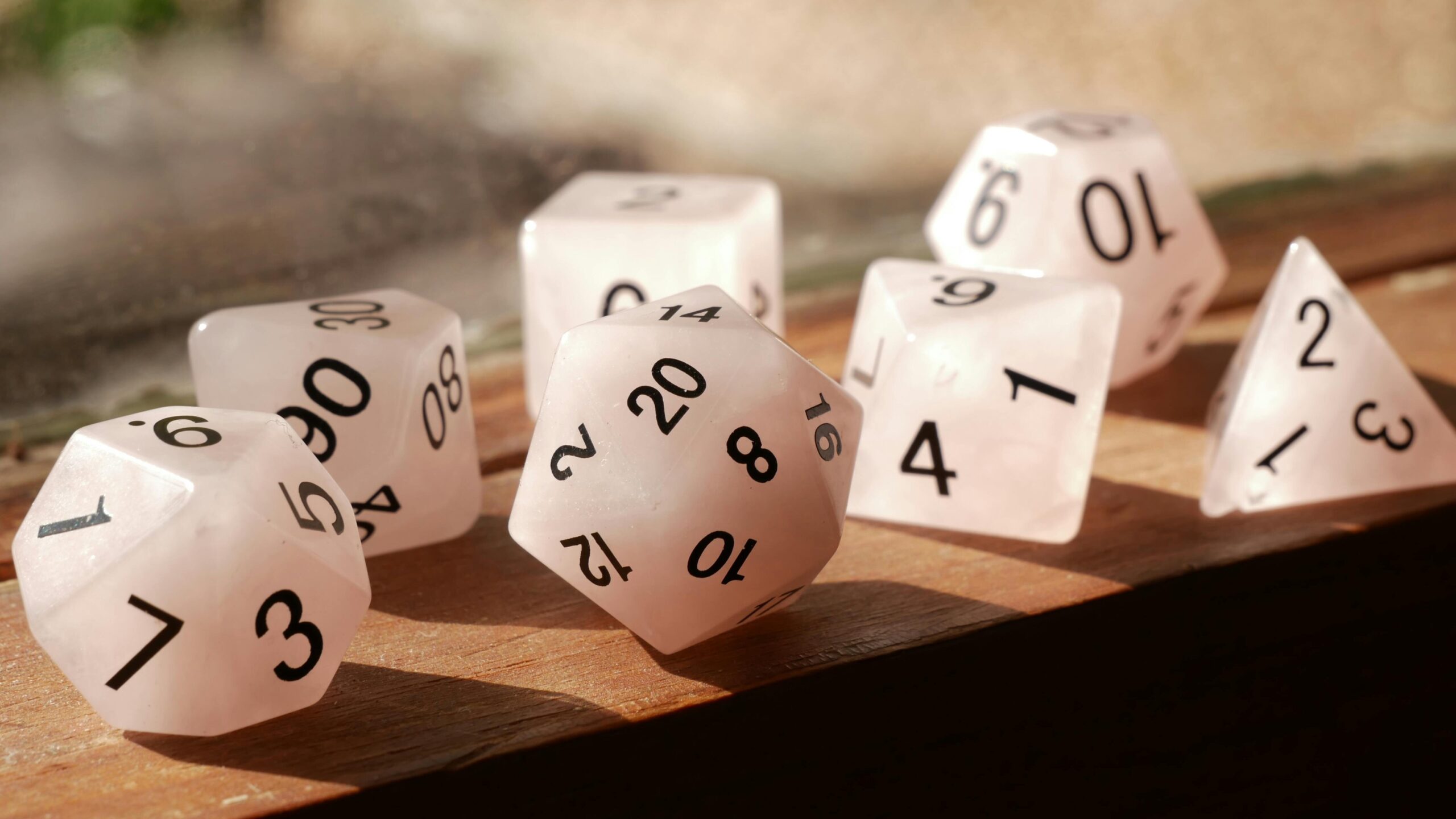 High-quality image of polyhedral dice on a wooden surface, perfect for gaming enthusiasts.